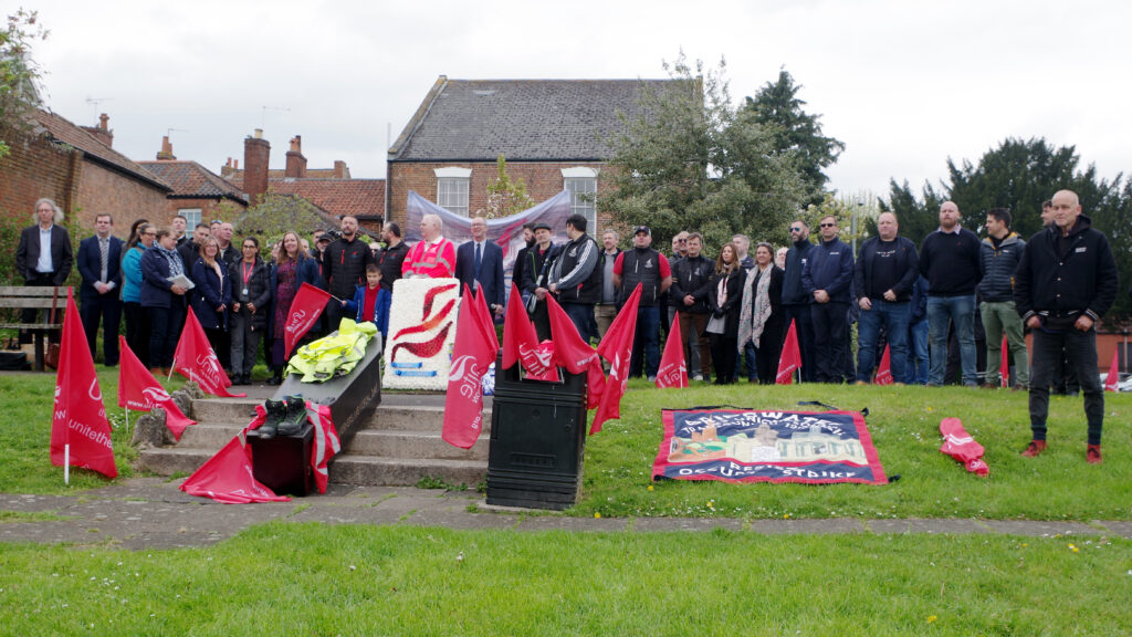 A coffin, flags and ceremonial wreaths from several unions surrounded the plinth in Blake Gardens, Bridgwater, which is a permanent memorial to workers killed or injured in the course of their work. PIcture © Kate Pearce 2024 